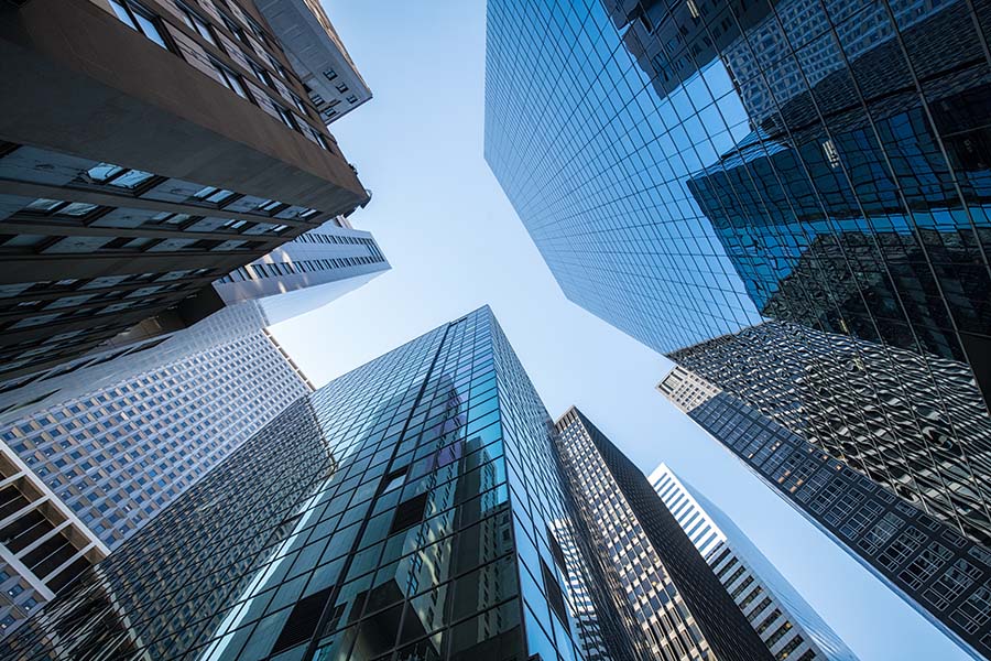 Business Insurance- View of Modern Skyscrapers Against Blue Sky