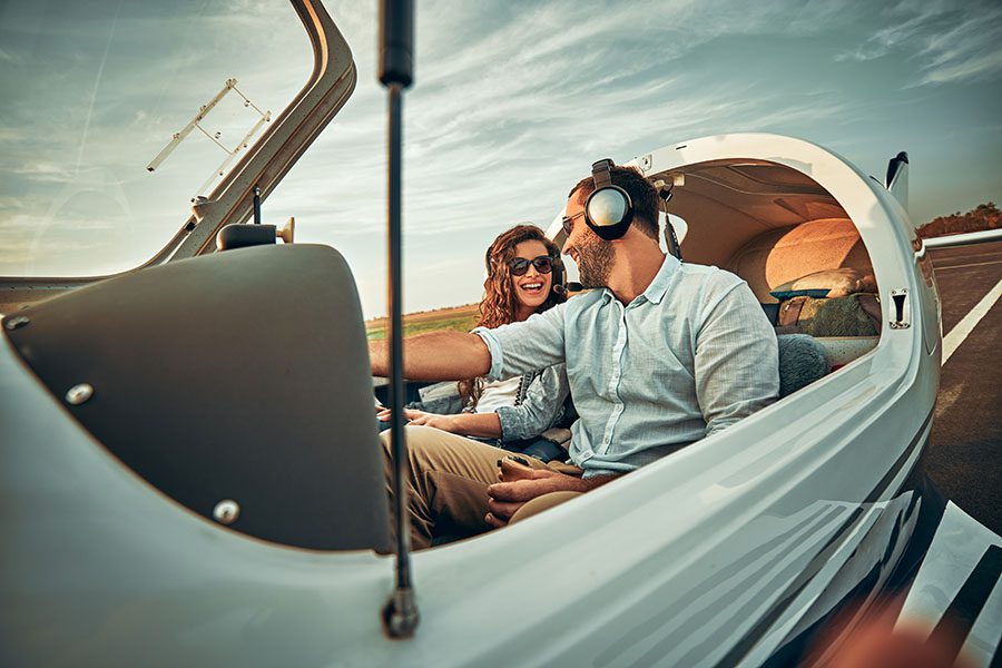 Private Aviation Insurance - Young Couple Having Fun Flying a Plane